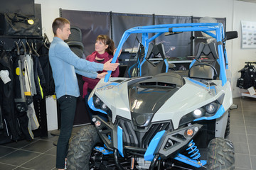 Young couple looking at buggy