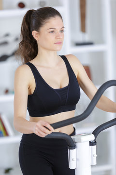 Girl at home on exercise machine
