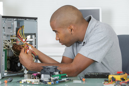 Man working on computer internals