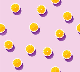 Seamless vector pattern of juicy oranges on a lilac background