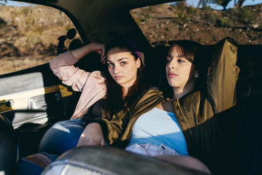 Women Sitting On Back Seat In Car