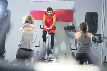 fit people in a spin class at the gym