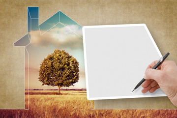 Hand writing on a blank sheet against a rural scene with a tree and a house outline - concept image...