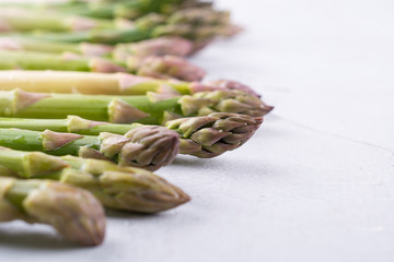 Spring season food.   Fresh white and green asparagus on a gray concrete background.  Space for text.Background for a recipe.