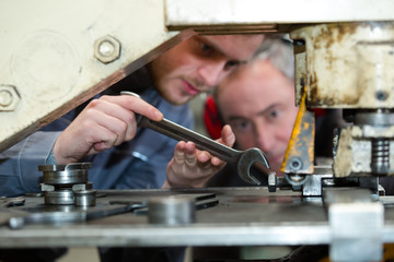 apprentice mechanic working in auto repair shop