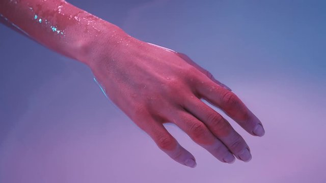 Young womans hand floating in Spa bath or swimming pool, she is very relaxed. Welness concept