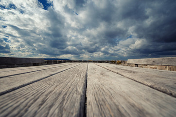 Wooden table outdoors under a dramatic sky