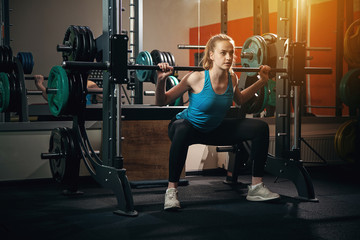  Beautiful sports girl is engaged in a gym.