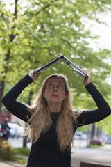 Scared business woman with her laptop outside