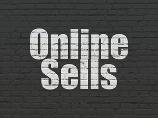 Advertising concept: Painted white text Online Sells on Black Brick wall background