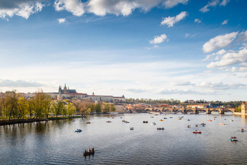 Fototapeta na wymiar Beautiful spring view on Prague Castle and tourist boats, Prague, Czech Republic