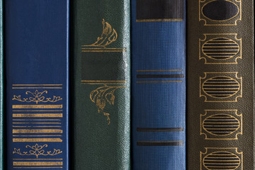 Close Up Of Old Books With Pattern On Shelf In Library. Texture Background.