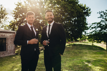 Groom and his friend at wedding party