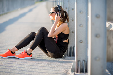 Sports woman resting on the bridge