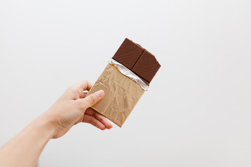 Hand holding a chocolate bar