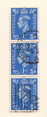 Leeds, England - April 20 2018: a row of old blue british penny postage stamps from the reign of king george the sixth