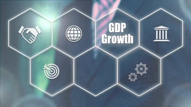 A businessman's hand selecting a GDP Growth concept button on a futuristic computer screen.