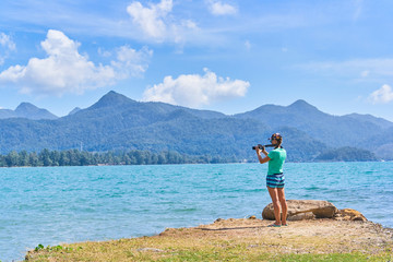 Beautiful woman is making a picture of scenic bay in Koh Chang island, Thailand