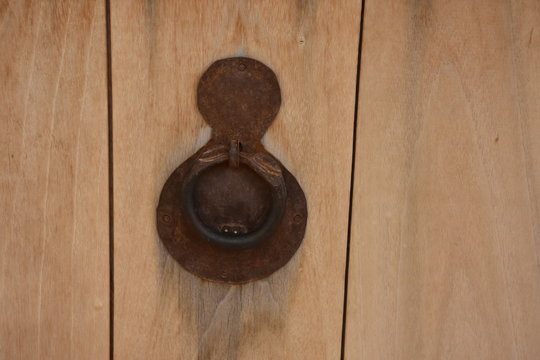 Old rusty metal lock and keyhole on a old brown wooden door as a vintage background