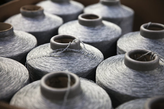 Close-up of silver spools of sewing thread