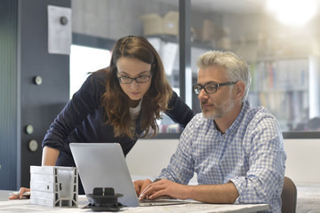 Industrial designers working together on project in office