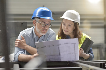 Metal industry manager and engineer meeting in factory