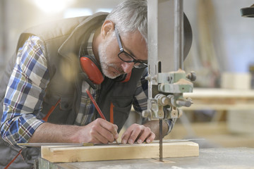 Woodworker in workshop designing piece of wood