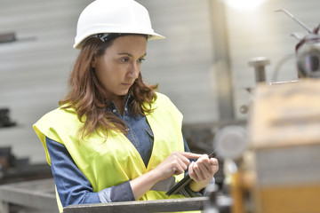 Metal industry engineer controlling work in factory