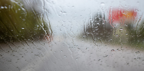 the background is out of focus. view from the window of a car in the rain