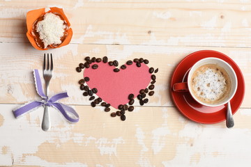 Obraz na płótnie Canvas Mug with coffee beverage, paper heart and coffee beans,