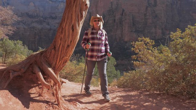 A Hiker Woman Walks On Trekking Footpaths The Red Rocks Of The Zion Canyon