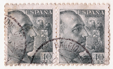 A pair of old blue vintage postage stamps with an image of general franco and the spanish eagle symbol - obrazy, fototapety, plakaty