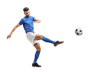 Fototapeta na wymiar Soccer player kicking a football