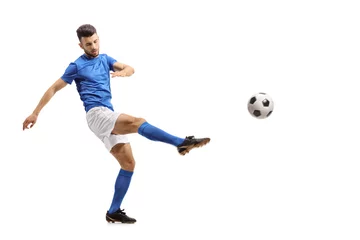 Poster Im Rahmen Soccer player kicking a football © Ljupco Smokovski