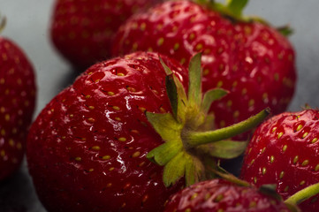 fresh ripe strawberries on black ceramic plate