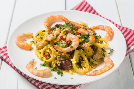 Paella with chicken, shrimp and squid rings