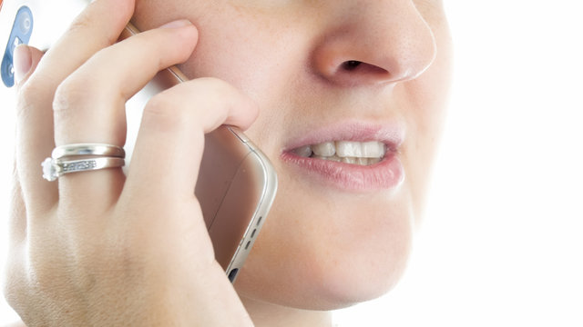 Closeup isolated image of young woman talking by mobile phone