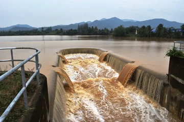 Papier Peint photo Barrage Turbid water in the dam overflows into the spillway  , Thailand  