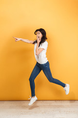 Fototapeta na wymiar Shocked woman jumping pointing.