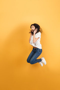 Shocked woman jumping isolated