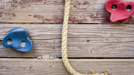 Closeup image of wooden wall with rope for climbing