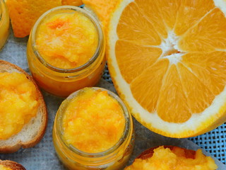 Bright homemade orange jam. Small jars with orange jam. Toast with orange jam. Bright yellow jam. Useful breakfast with citrus fruits