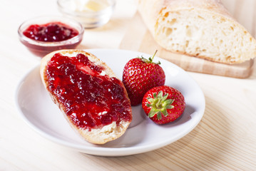 sandwich with strawberry jam on the table