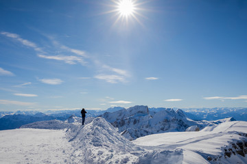 Naklejka na ściany i meble Man looking at the beautiful Winter Panorama in the Swiss Alps