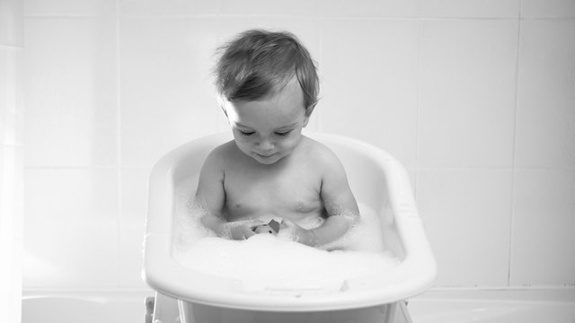 Black And White Portrait Of Toddler Boy Ahnving Bath With Suds