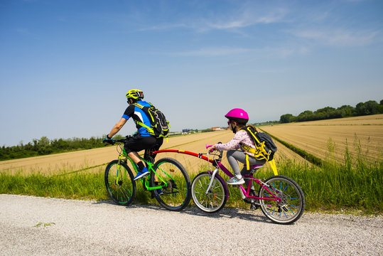 Father and daughter going in bicycle