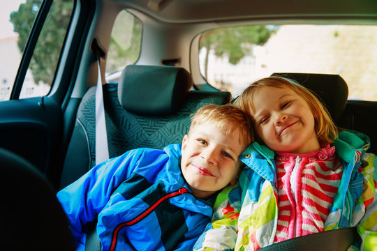 happy kids-boy and girl- travel by car