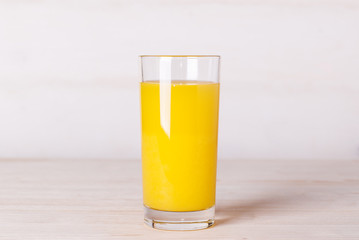 glass of orange juice on a table
