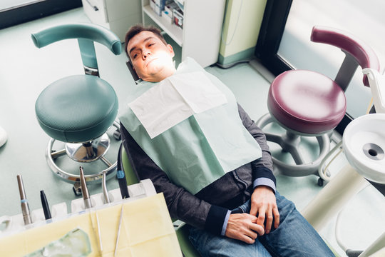 Male patient in dentist chair, elevated view