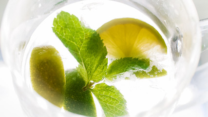 View from above on glass of cold water with mint and lemon